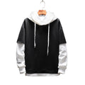 Black and white hoodie on a hanger against a white background