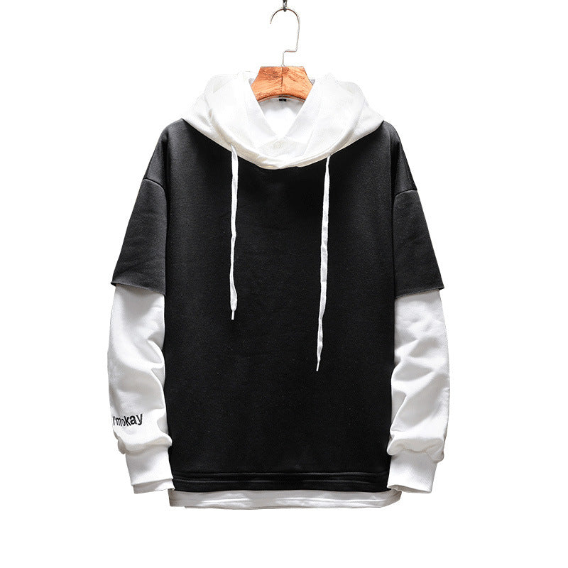 Black and white hoodie on a hanger against a white background