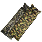 Camouflage-patterned inflatable sleeping pad with two pillows on a white background