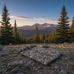 Camouflage-patterned sleeping bag on a white background