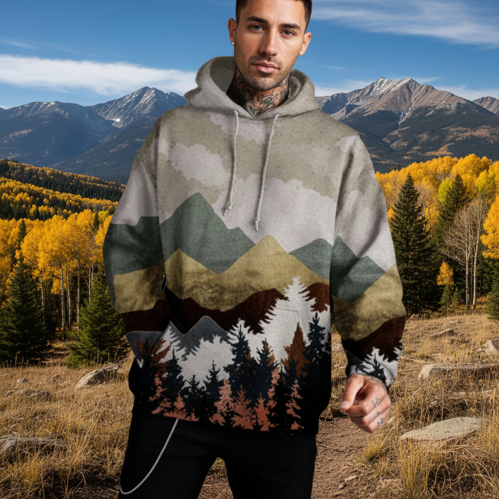 Man wearing Mountain hoodie with Colorado mountain scene behind him.