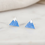 Mountain Peak Stud Earrings on marble.