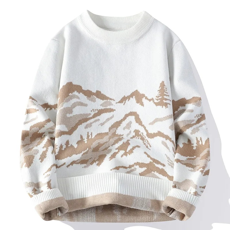 White sweater with mountain and tree pattern on a white background