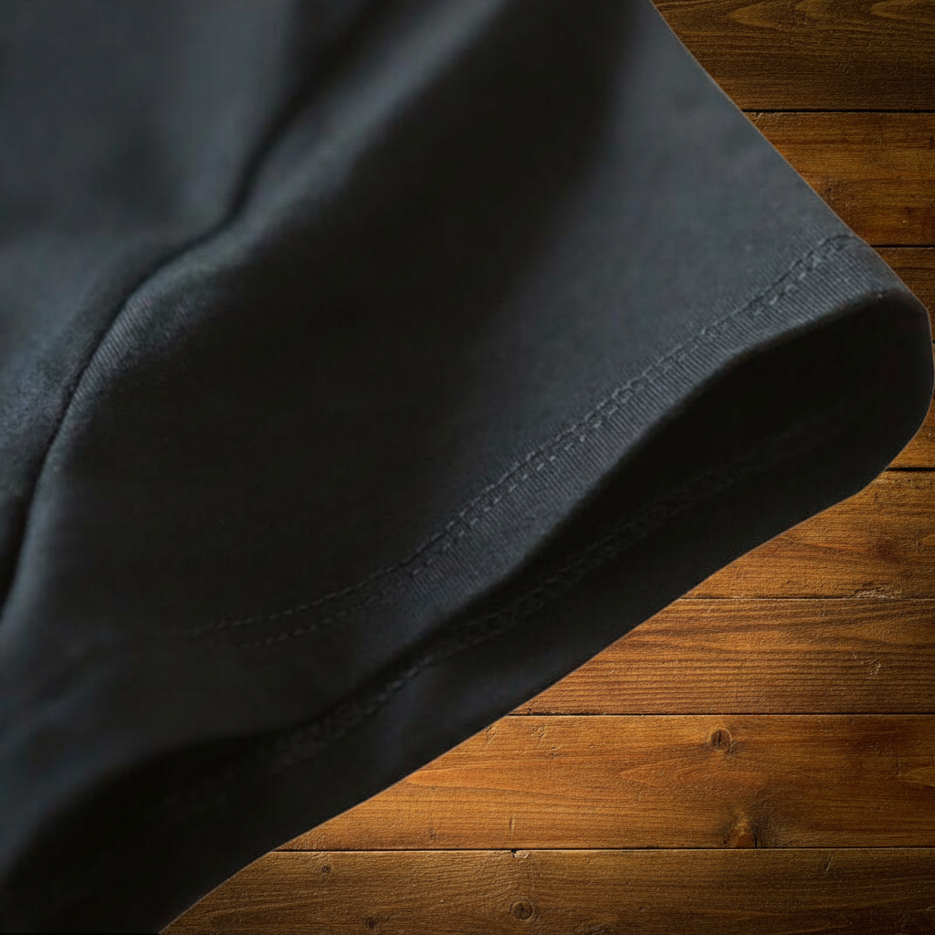 Black Tee Detail on Wood Background