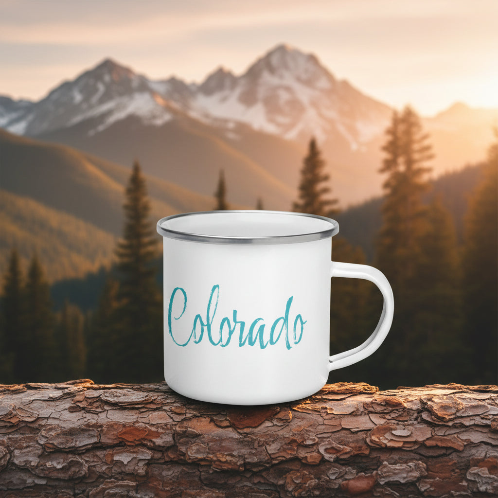 White mug with 'Colorado' written in teal with a Colorado mountain scene behind it. 